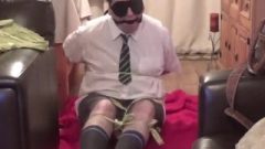 Dude Tied Up And Gagged Tightly In School Uniform With Strips Of Cloth
